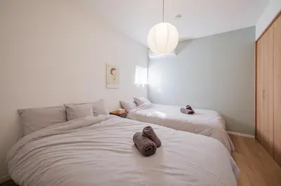 a bedroom with two beds with towels on them at Tokyo Kanamachi Inn in Tokyo