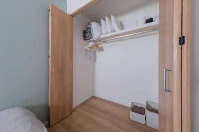 a bedroom with a door open to a closet at Tokyo Kanamachi Inn in Tokyo