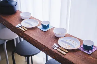 a wooden table with plates and utensils on it at Tokyo Kanamachi Inn in Tokyo