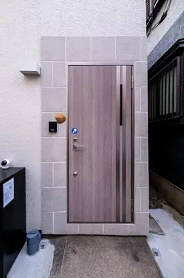 a wooden door on the side of a building at Tokyo Kanamachi Inn in Tokyo