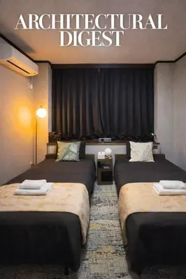 a hotel room with three beds with the words architectural digest at Mando Hotel 301 ,direct to Ueno ,Asakusa in Tokyo