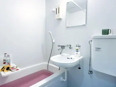 a white bathroom with a sink and a mirror at Mando Hotel 301 ,direct to Ueno ,Asakusa in Tokyo