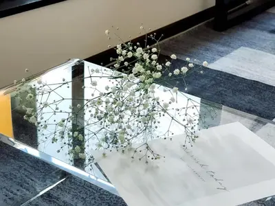 a glass table with a vase of flowers on it at Mando Hotel 301 ,direct to Ueno ,Asakusa in Tokyo