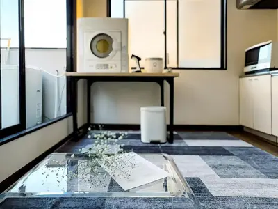a room with a glass table and a microwave at Mando Hotel 301 ,direct to Ueno ,Asakusa in Tokyo