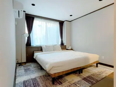 a bedroom with a bed and a large window at Mando Hotel 401 ,direct to Ueno, Asakusa in Tokyo