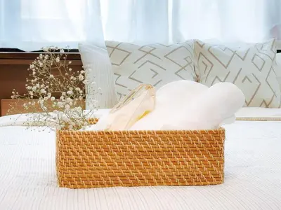 a basket of towels sitting on a bed at Mando Hotel 401 ,direct to Ueno, Asakusa in Tokyo