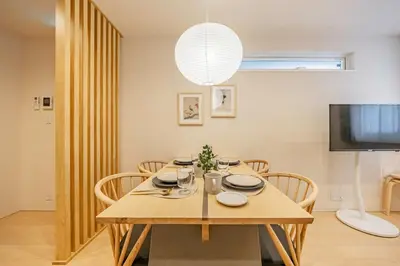a dining room with a table with chairs and a television at \u4e09\u8ed2\u8336\u5c4bCasa Blanky in Tokyo