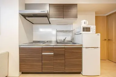 a kitchen with a sink and a white refrigerator at \u4e09\u8ed2\u8336\u5c4bCasa Blanky in Tokyo