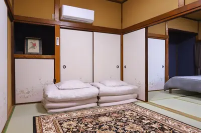 a bedroom with white cabinets and a bed and a rug at \u7985-zen-Tokyo Itabashi in Tokyo