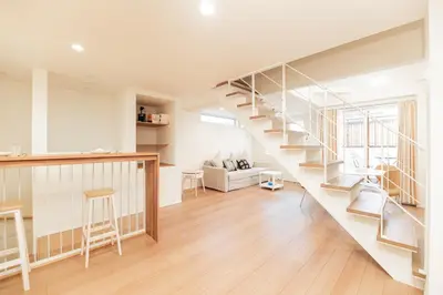 a living room with a spiral staircase in a house at \u76ee\u767d\u522b\u5885 \u5168\u65b03\u5c42\u697c\u72ec\u680b\u522b\u5885\u5bb6\u7684\u611f\u89c9 3\u5367\u5ba4Brand new 3-story detached villa with a homey feel 3 rooms \u8fd1\u5546\u5708 \u8bbe\u5907\u9f50\u5168 \u76f4\u8fbe\u65b0\u5bbf \u94f6\u5ea7 \u6d89\u8c37 \u4e0a\u91ce \u8868\u53c2\u9053 \u54c1\u5ddd in Tokyo
