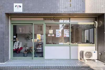 a store front with a large glass door at M's GARDEN KIYOSUMI in Tokyo