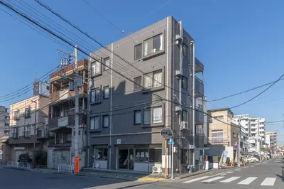a building on the corner of a street at M's GARDEN KIYOSUMI in Tokyo