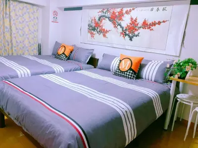 three beds in a room with purple and orange at Kabuki house in Tokyo