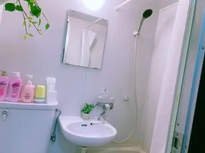 a white bathroom with a sink and a mirror at Kabuki house in Tokyo