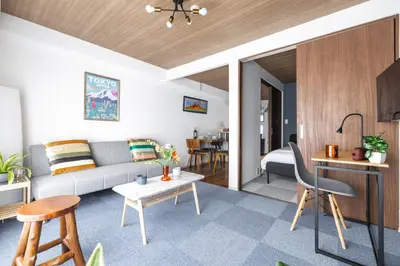 a living room with a couch and a table at Happy House Residence in Tokyo