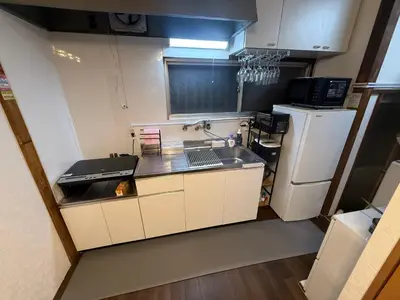a small kitchen with a sink and a refrigerator at \u307b\u307e\u308c\u53e4\u6c11\u5bb6\u4e00\u68df\u8cb8\u3057\u65b0\u5c0f\u5ca9\u99c5\u5f92\u6b6917\u5206 in Tokyo