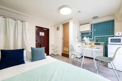 a small room with a bed and a small kitchen at Kamimachi Stay102 in Tokyo