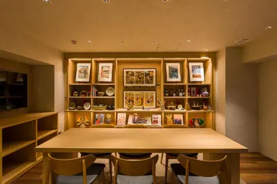 a dining room with a wooden table and chairs at Sumu Ueno East in Tokyo