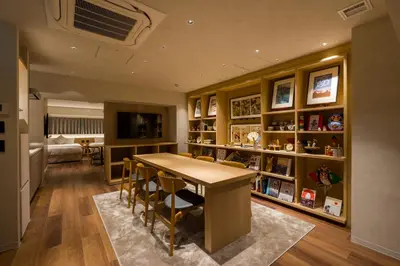 a dining room with a table and some shelves at Sumu Ueno East in Tokyo