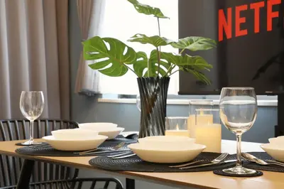 a dining room table with a vase with a plant at AirHOMETOKYO EBISU 202 in Tokyo
