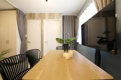a wooden table with candles and a potted plant on it at AirHOMETOKYO EBISU 202 in Tokyo