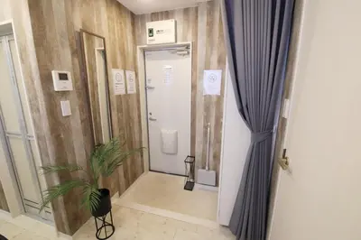 a bathroom with a toilet and a potted plant at AirHOMETOKYO EBISU 202 in Tokyo
