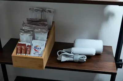 a wooden table with a shelf with products on it at Kaminari INN in Tokyo