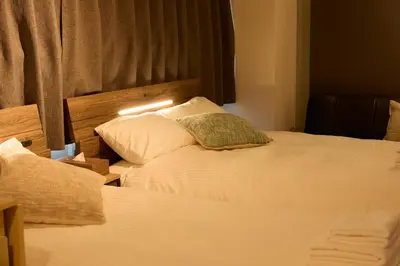 a hotel room with two beds and a lamp at Kaminari INN in Tokyo