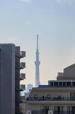 a view of the eiffel tower from the roofs of buildings at Chill Place 133 Keisei Koiwa in Tokyo