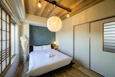 a bedroom with a large white bed in a room at Chill Place 133 Keisei Koiwa in Tokyo