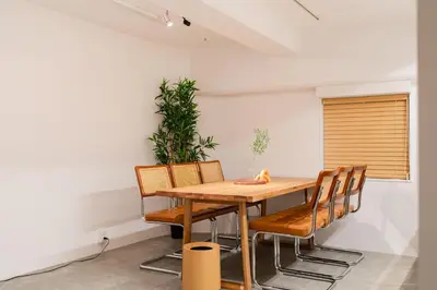 a dining room with a wooden table and chairs at Shibuya Beatles house 10min walk from Shibuya Station in Tokyo