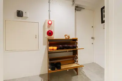 a shelf in a room with a red light at Shibuya Beatles house 10min walk from Shibuya Station in Tokyo
