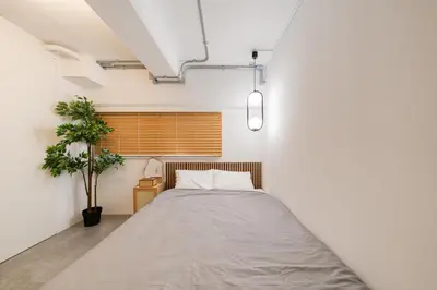 a bedroom with a bed and a window at Shibuya Beatles house 10min walk from Shibuya Station in Tokyo