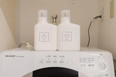 two bottles sitting on top of a washing machine at Shibuya Beatles house 10min walk from Shibuya Station in Tokyo