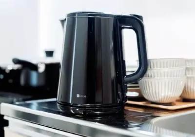 a black kettle sitting on top of a stove at Alice JueQie 1minute walk to Horikiri Station ,Super convenient transportation ,Direct access to Narita Airport , Drugstore, convenience store, and shopping center downstairs in Tokyo