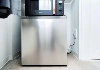 a microwave oven sitting on top of a refrigerator at Alice JueQie 1minute walk to Horikiri Station ,Super convenient transportation ,Direct access to Narita Airport , Drugstore, convenience store, and shopping center downstairs in Tokyo