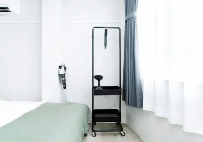 a bedroom with a mirror next to a bed at Alice JueQie 1minute walk to Horikiri Station ,Super convenient transportation ,Direct access to Narita Airport , Drugstore, convenience store, and shopping center downstairs in Tokyo