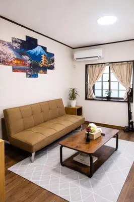 a living room with a couch and a coffee table at Maison du Skytree Tokyo in Tokyo
