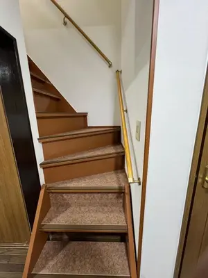 a staircase in a house with a wooden railing at Maison du Skytree Tokyo in Tokyo