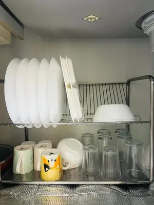 a shelf with plates and other dishes in a kitchen at Maison du Skytree Tokyo in Tokyo