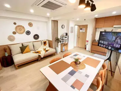 a living room with a couch and a table and a tv at Designer 2BR with Japanese & Western Style Near Shinjuku Subway 5-Min up to 6 people in Tokyo