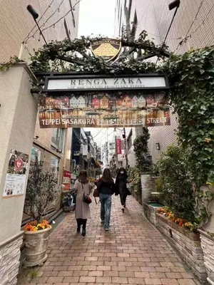 a group of people walking down a brick street at Designer 2BR with Japanese & Western Style Near Shinjuku Subway 5-Min up to 6 people in Tokyo