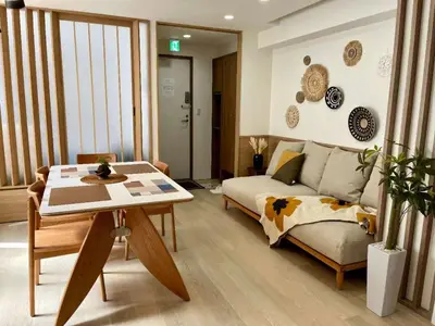 a living room with a couch and a table at Designer 2BR with Japanese & Western Style Near Shinjuku Subway 5-Min up to 6 people in Tokyo