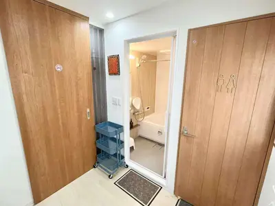 a small bathroom with a toilet and a door at Designer 2BR with Japanese & Western Style Near Shinjuku Subway 5-Min up to 6 people in Tokyo