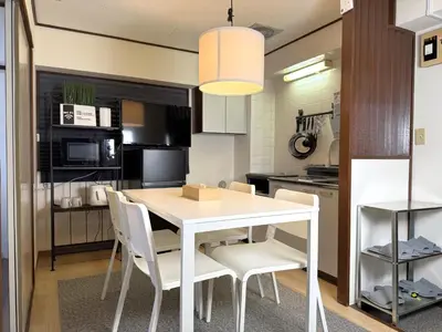 a kitchen and dining room with a white table and chairs at LT Oshiage in Tokyo