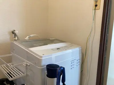 a washing machine sitting in a room with a washer at LT Oshiage in Tokyo