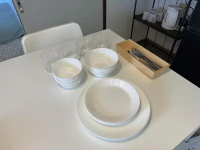 a table with plates and glasses on a table at LT Oshiage in Tokyo