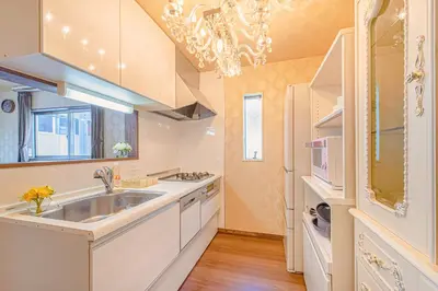 a large kitchen with a sink and a chandelier at princess castle JR Takadanobaba 5 mins Shinjuku area in Tokyo