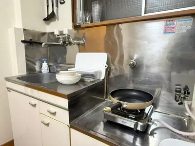 a kitchen with a pan on a stove at Nogata RelaxingHome E2 in Tokyo