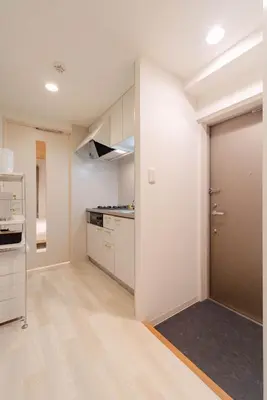 a kitchen with white cabinets and a door at House Hotel Shin Ekoda401 DE41 in Tokyo